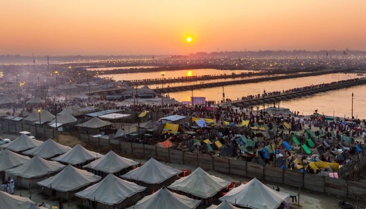 Hindu pilgrims crossing pontoon bridges into the Kumbha Mela campsite, India.